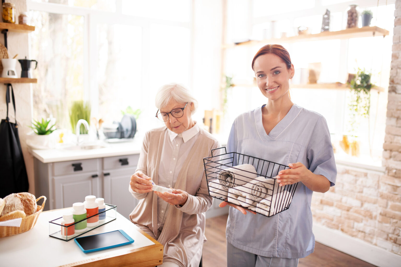 Personal female caregiver standing near retired woman
