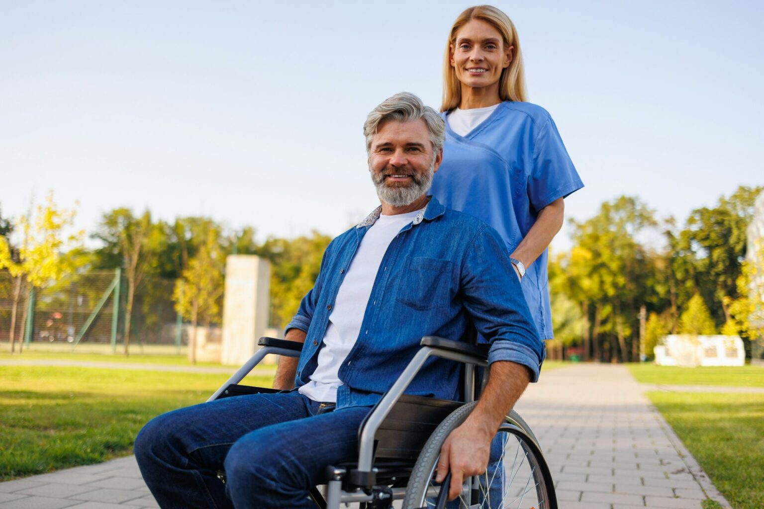 Caregiving in Motion: Nurse Guiding Wheelchair Outdoors