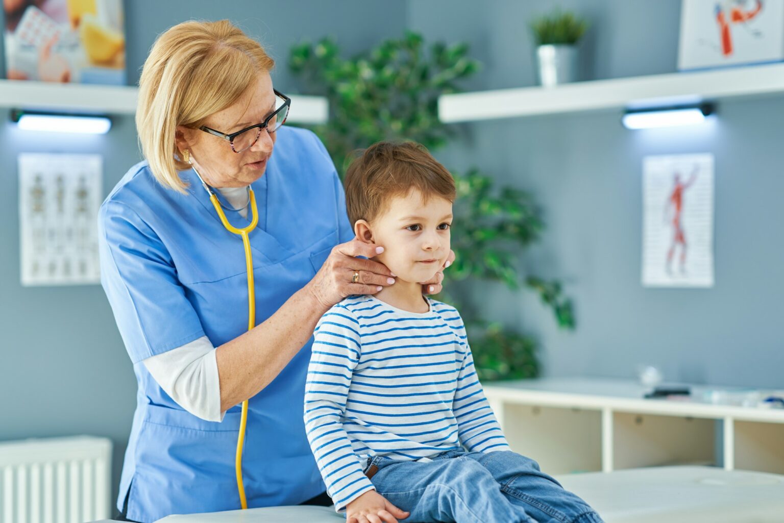 Pediatrician doctor examining little kids in clinic
