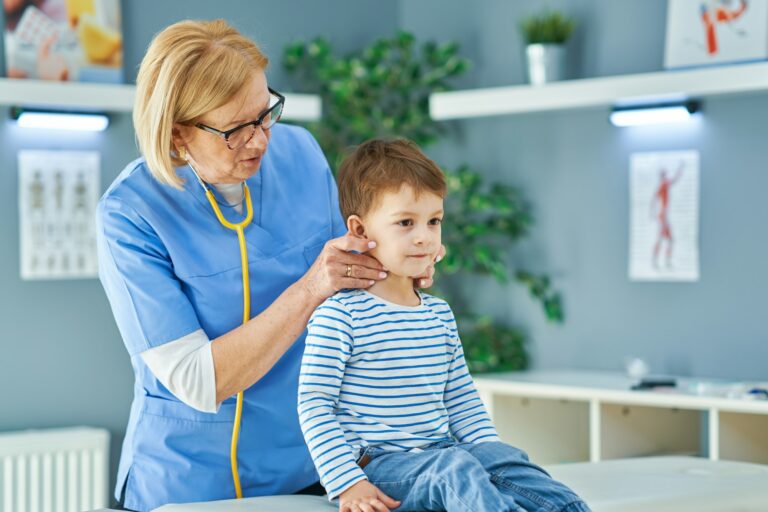 Pediatrician doctor examining little kids in clinic
